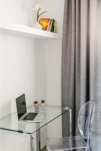 a glass desk with a laptop on top of it at Michelangelo Resort Apartments in San Miguel de Abona