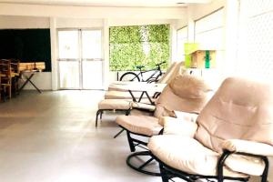 a living room with three chairs and a couch at 8 Bedroom Subic Bay/300MBPS/Big Screened Lanai in Sawat