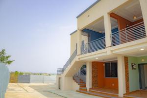 a building with a staircase in front of it at CMP APARTMENTS in Kasoa