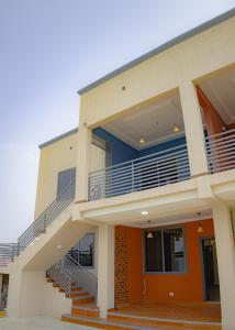 a building with stairs in front of it at CMP APARTMENTS in Kasoa