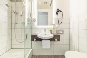 a bathroom with a shower and a sink at CityClass Hotel am Dom in Cologne