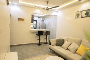 a living room with a couch and a sink at CMP APARTMENTS in Kasoa