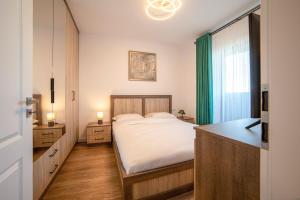 Ένα ή περισσότερα κρεβάτια σε δωμάτιο στο Ansamblul Rezidențial Avanera.