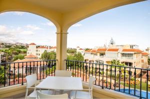 a balcony with a table and chairs and a view at Michelangelo Resort Apartments in San Miguel de Abona