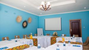 a meeting room with white tables and a white board at Kaweta Cottage in Nkhata Bay