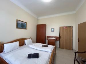 a bedroom with a large bed and a bathroom at Hotel Monika in Cheb