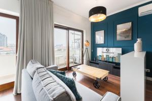 un soggiorno con un divano e un tavolo di GuestReady - Almada 516 a Porto