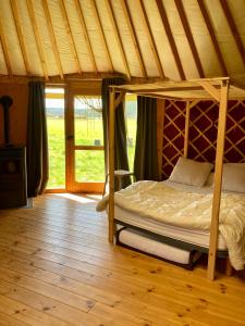 a bedroom with a bed in a tent at Yourte tout confort éco-responsable in Saint-Pierre-Eynac