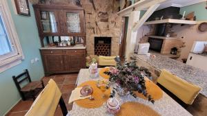 a dining room with a table with flowers on it at La casita "A de Naval" in Pontevedra