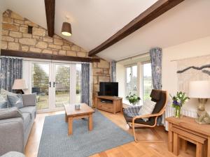 a living room with a couch and a tv at 2 bed property in Whitton Northumberland 61267 in Rothbury