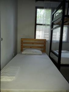 a bed in a room with a bunk bed at The Nest Haven Hostel in Dar es Salaam