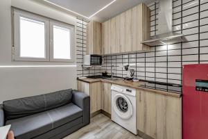 a kitchen with a washing machine and a red refrigerator at Apartamentos Santiago Cordero in Madrid