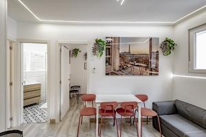 a living room with a white table and chairs at Apartamentos Santiago Cordero in Madrid