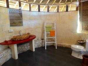 a bathroom with a sink and a toilet at Vertical House Bali in Uluwatu