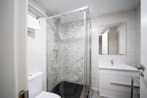 a bathroom with a shower and a toilet and a sink at Apartamentos GO - Leopoldo Cano Center in Valladolid