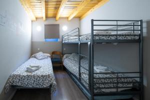 a room with two bunk beds and a table at Apartamentos GO - Leopoldo Cano Center in Valladolid