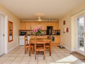 a dining room with a wooden table and chairs at 2 bed property in Bala 86964 in Llandderfel