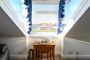 a small table in a room with a window at Coast Guest House in Whitby
