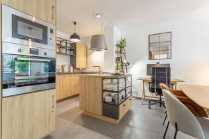 a kitchen with a table and a dining room at L’hermine avec parking 500m plage in Concarneau