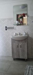 a bathroom with a sink and a mirror at 7 on school - Cozy guesthouse 15 min drive from airport and close to major highways in Germiston