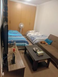 a living room with a couch and a bed at 7 on school - Cozy guesthouse 15 min drive from airport and close to major highways in Germiston
