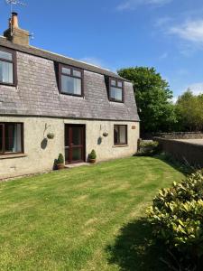 a house with a green lawn in front of it at Ardmuir in Turriff +3 photos