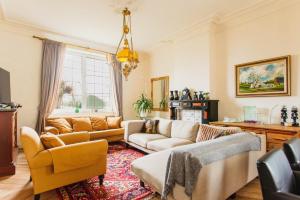 a living room with two couches and a rug at Beautiful mansion with swimming pool and jacuzzi in Bilzen