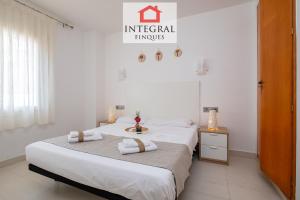 two beds in a room with white walls at La Perla del Mar - Casa la Fosca in Palamós