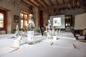 a bottle of water sitting on top of a table at Hôtel la Maison de Rhodes & Spa in Troyes