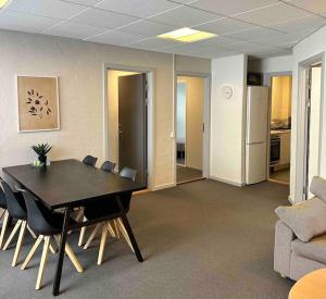 a conference room with a table and chairs and a couch at City 6-bedroom, private parking. in Aalborg