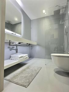 a bathroom with a glass shower and a sink at Attica Résidences, Lausanne in Saint-Sulpice