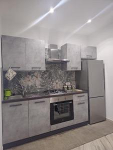 a kitchen with a stove and a refrigerator at Il Profumo di Capri in Massa Lubrense