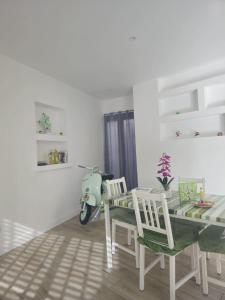 a dining room with a table and a scooter at Il Profumo di Capri in Massa Lubrense