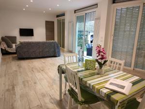a living room with a table and chairs and a couch at Il Profumo di Capri in Massa Lubrense