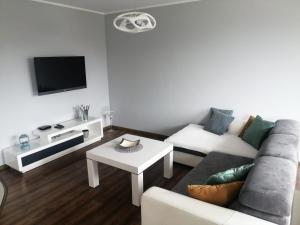 a living room with a couch and a table at Apartament 35 in Olsztynek