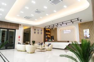 a lobby of a hotel with chairs and a counter at indigo Hotel Hatyai in Ban Kohong