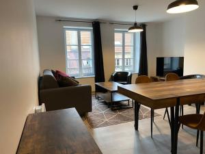 a living room with a couch and a table at Hypercentre * Calme * Cosy - Le Citadin in Pontarlier