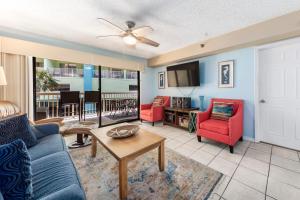 a living room with a couch and chairs and a table at Harbour Place Unit 106 in Orange Beach