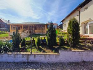 a house with a yard with trees and a fence at Belvedere La Cristina in Corbeni