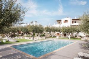 a swimming pool in the yard of a house at Sunset Paros Naousa in Naousa