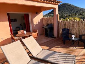 a patio with chairs and a table and a grill at Appartement 2 chambres, mezzanine et piscine in Porto-Vecchio +7 photos