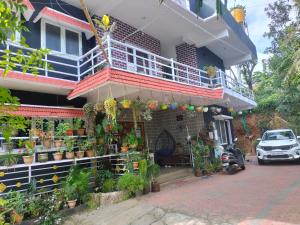 a house with plants on the side of it at Coorg Kusuma's budget homes in Madikeri