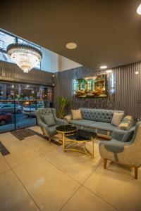 a living room with a couch and chairs and a chandelier at Liza Suit Hotel in Istanbul