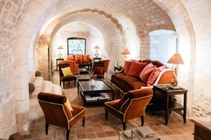 a living room with a couch and chairs at La Maison de Rhodes Hôtel & Spa in Troyes