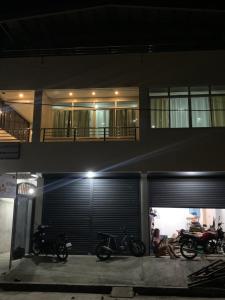 two motorcycles parked in front of a building at night at Tending's Rendezvous in Santa Monica