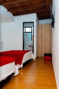 a bedroom with two beds and a bathroom at HOTEL Y RESTAURANTE SHALOM in Pamplona