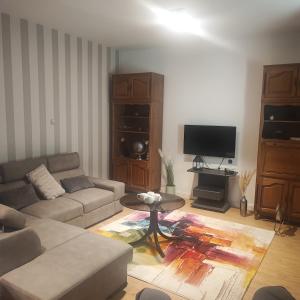 a living room with a couch and a table at Vila Bartulović in Kučiće