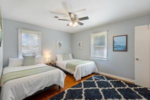 a bedroom with two beds and a ceiling fan at Spacious 5BR Home 10 Min Walk to Augusta Ntl Golf in Augusta