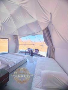 a bedroom with two beds in a tent at RUM ROYAL BUBBLES lUXURY CAMP in Wadi Rum