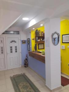 a hallway with a white door and a yellow wall at Apartments & Rooms L E F T RIVER Belgrade in Belgrade